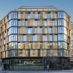 EADA Modern building with wooden facade, in an urban setting.