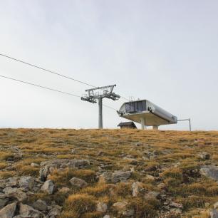 Cable car station on a barren, grassy landscape.