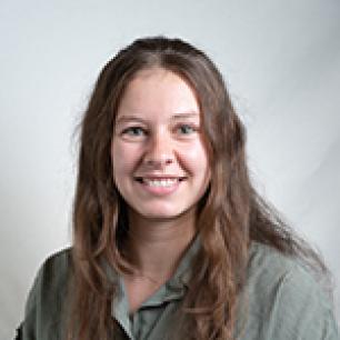 Young woman with long brown hair, smiling.