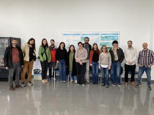 Group of people posing for a photo, indoors.