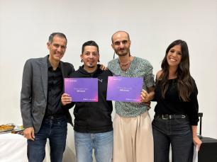 Four people smiling and holding certificates.