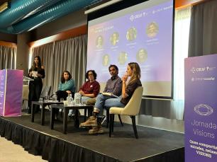 Panel of six people on stage presenting at a conference.