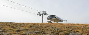 Cable car station on a barren, grassy landscape.