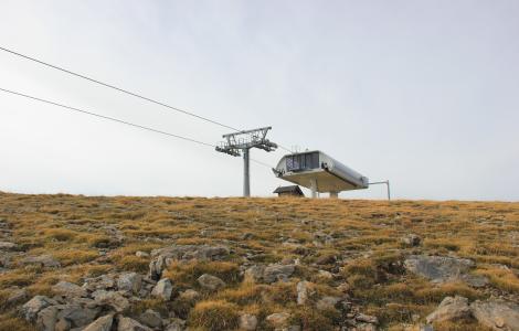 Cable car station on a barren, grassy landscape.