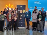 Group of people smiling, posing for a photo.