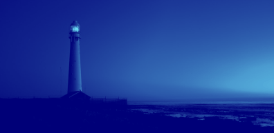 Lighthouse with a glowing beacon at night. Dark blue tones.