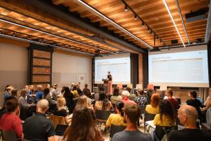 Audience at a presentation in a modern room.