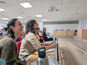 People laughing in a lecture hall.