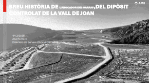 Photograph of a valley with a road running through it.