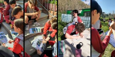 Children studying outside, working on assignments.